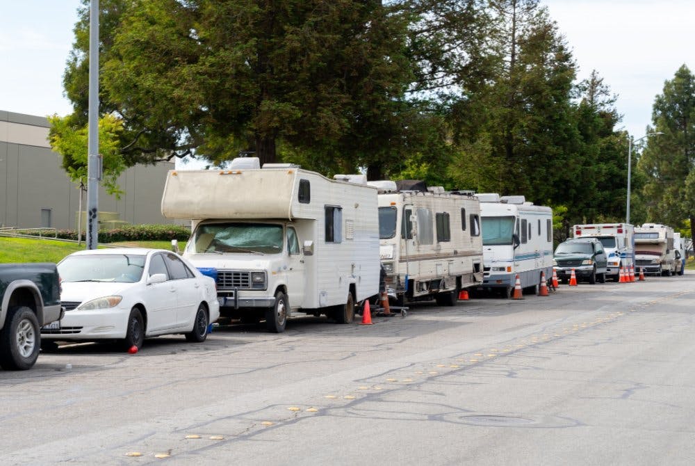 Street view of parked RV's and cars.